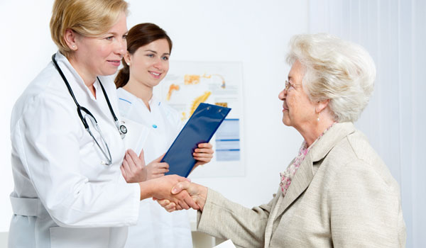 Eine Ärztin verabschiedet eine ältere Patientin.